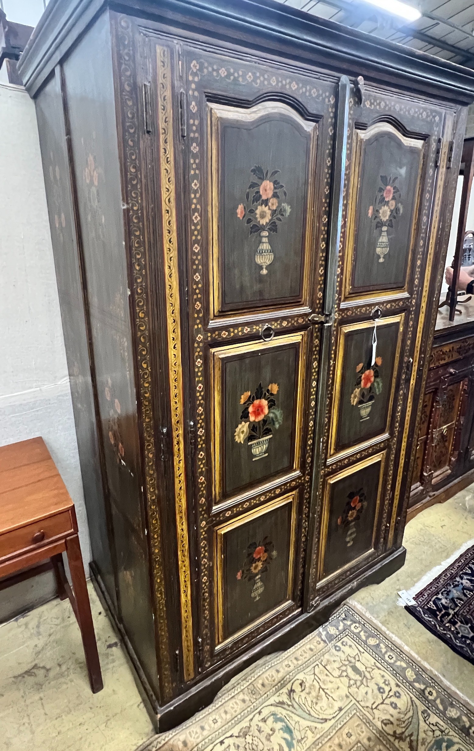 An Indian painted hardwood two door cupboard, width 120cm, depth 70cm, height 185cm